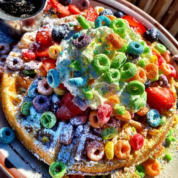 Eat'n Park's colorful waffle topped with whipped cream, Froot Loops, strawberries, blueberries, and powdered sugar.